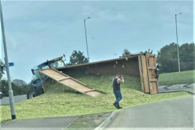 Overturned tractor trailer spills its contents all over the road