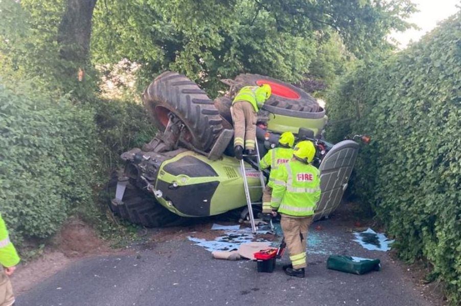 Tractor overturns on country lane in Gloucestershire