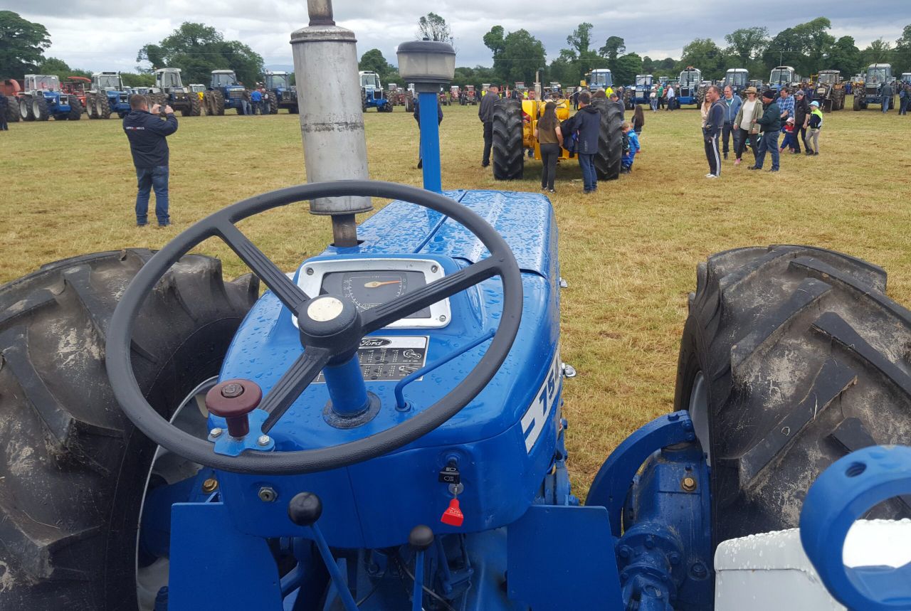 99 County tractors cluster together in one field