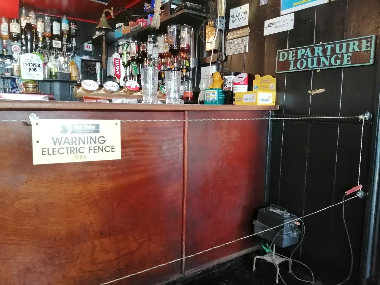Pub installs electric fence to ensure social distancing at bar