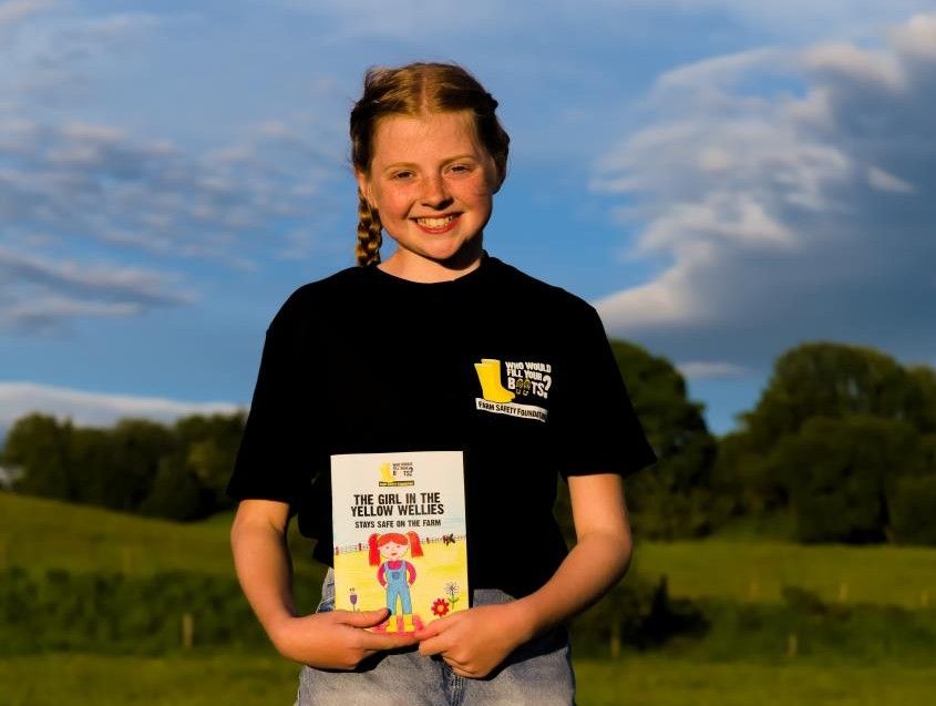 Erin Thompson, England's Farm Safety Hero 2025, holding her new book in collaboration with Yellow Wellies. Source: Costas Andreou